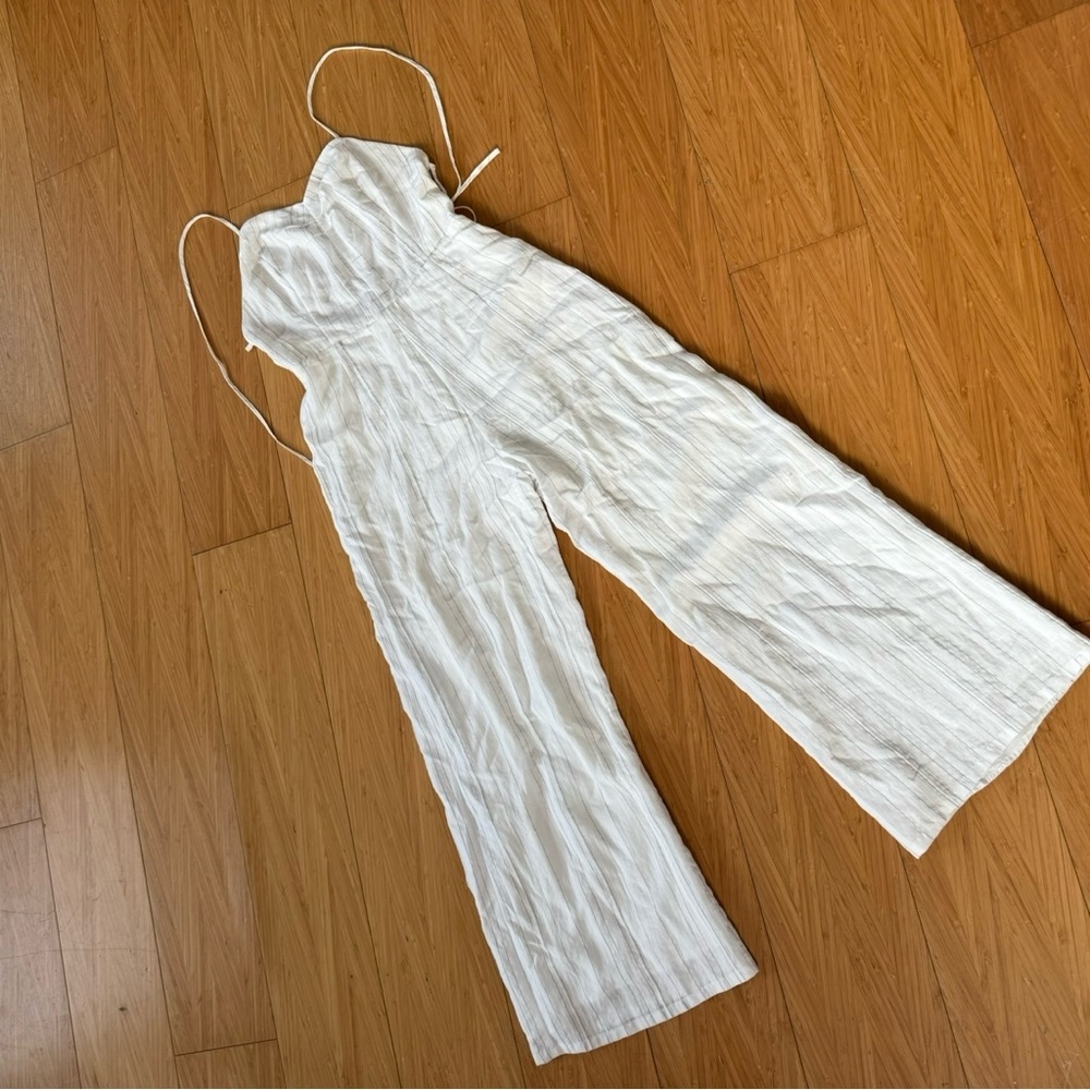 White jumpsuit with open back.